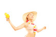 Relaxed blond female in bikini holding a cocktail