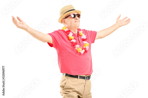 Photo: Happy mature man on a vacation spreading his arms Happy mature man on a vacation spreading his arms