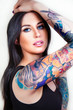 Beautiful girl with stylish make-up and tattooed arms.
