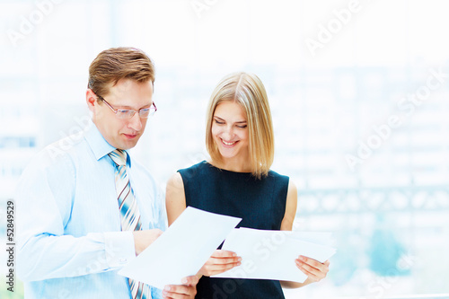 Photo: Two young business collegues. Two young business collegues.