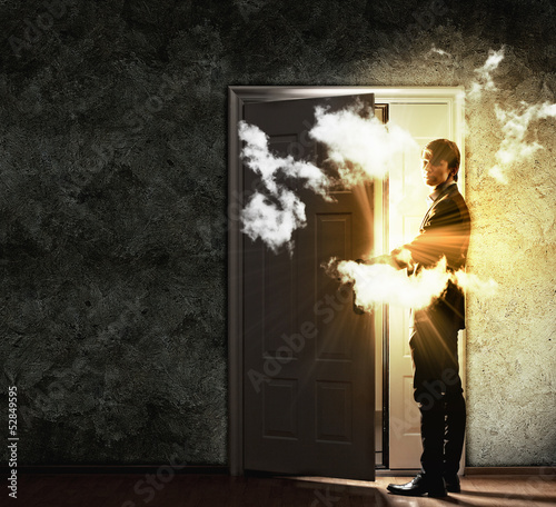 Photo: Young businessman opening door Young businessman opening door