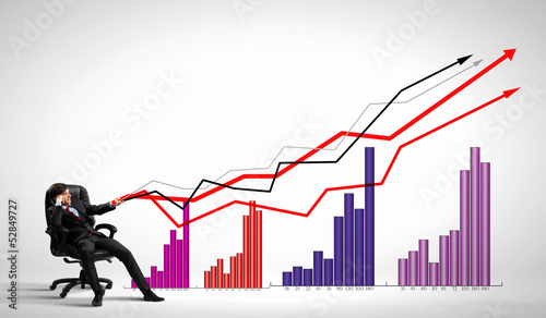 Photo: Businessman pulling graph Businessman pulling graph