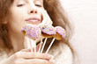 Beautiful young girl holding cake pops, very soft and selective