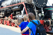 family looking at steam train
