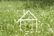 Photo: Wooden home in spring green grass ecological building concept Wooden home in spring green grass ecological building concept