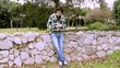 Handsome man texting with cell phone in park