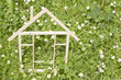 Photo: Wooden home in spring green grass ecological building concept Wooden home in spring green grass ecological building concept