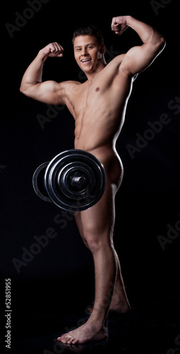 Photo: Smiling muscular nude heavyweight posing with rod Smiling muscular nude heavyweight posing with rod