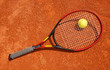 Photo: Tennis ball and racket on the court Tennis ball and racket on the court