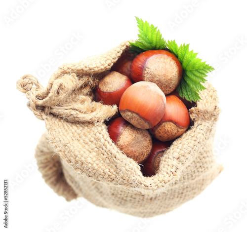 Photo: Hazelnuts in sack isolated Hazelnuts in sack isolated