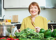 woman cooking vegetables in domestic kitchen