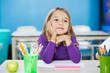 Thoughtful Girl With Hand On Chin Sitting At Desk