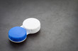 Contact lens case on dark background.