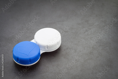 Photo: Contact lens case on dark background. Contact lens case on dark background.