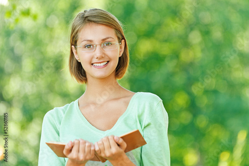 Photo: young woman glasses read book young woman glasses read book