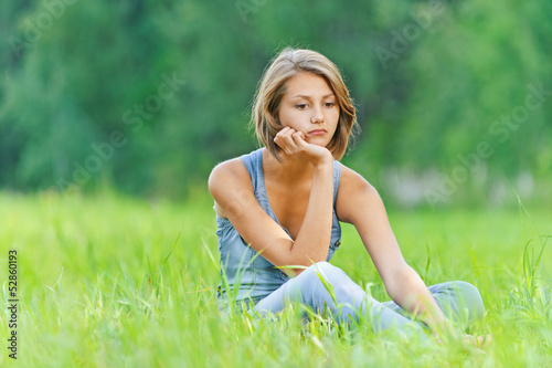 Photo: young woman sitting grass young woman sitting grass