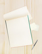 Blank notepad with pen on wood table, free space for text