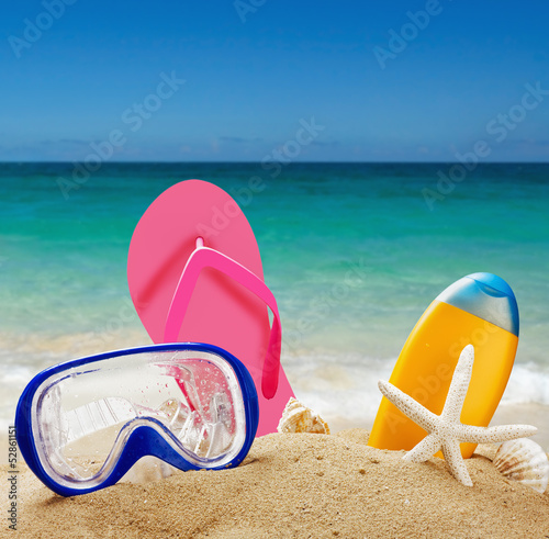 Photo: beach accessories in the sand against the sea landscape beach accessories in the sand against the sea landscape