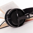 Headphones and book on a white background