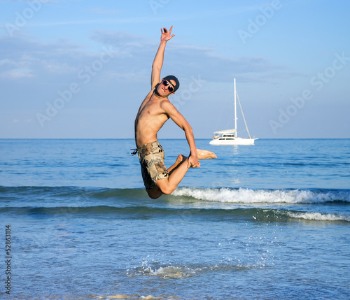 Photo: Man jumping on beach Man jumping on beach