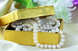 pearl necklace in a gold gift box