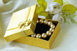 pearl necklace in a gold gift box