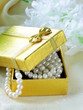 pearl necklace in a gold gift box