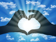 heart made with fingers on blue sky background