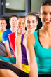 Photo: Group of people and instructor in gym stretching Group of people and instructor in gym stretching