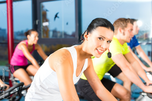 Photo: group doing sport Spinning in the gym for fitness group doing sport Spinning in the gym for fitness