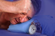Man can not sleep and looked at the alarm clock
