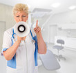 Mature doctor with megaphone