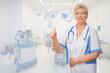 Mature doctor shows ok gesture