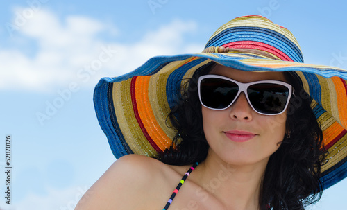 Photo: Beautiful woman in a summer sunhat Beautiful woman in a summer sunhat