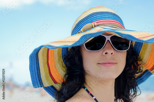 Photo: Pretty woman wearing a colourful sunhat Pretty woman wearing a colourful sunhat
