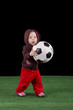Photo shows a baby with a football