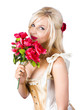 Adorable florist woman smelling red flowers