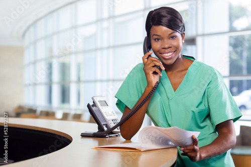 Photo: Smiling nurse at work station Smiling nurse at work station