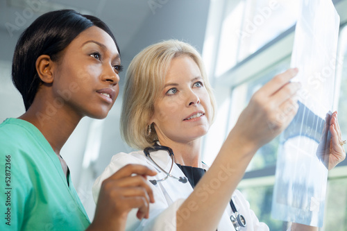 Photo: Female nurse and doctor looking at xrays Female nurse and doctor looking at xrays