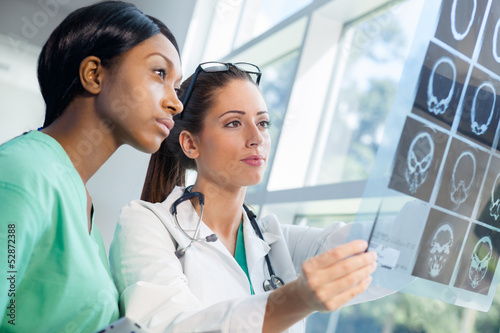 Photo: Female nurse and doctor looking at xrays Female nurse and doctor looking at xrays