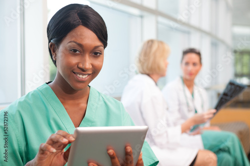 Photo: Smiling nurse with two doctors Smiling nurse with two doctors