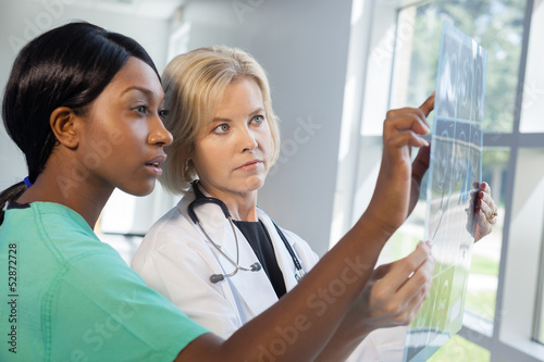Photo: Female nurse and doctor looking at xrays Female nurse and doctor looking at xrays