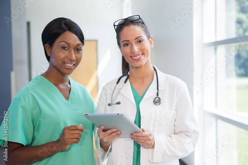 Photo: Female nurse and doctor with tablet computer Female nurse and doctor with tablet computer