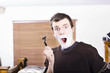Shocked male with shaving cream and razor blade