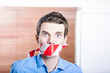 Businessman in silence with red warning tape