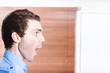 Surprised advert man looking in shock to copyspace