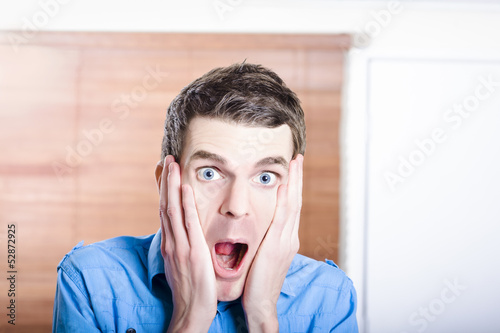 Photo: Face of an excited businessman inside workplace Face of an excited businessman inside workplace