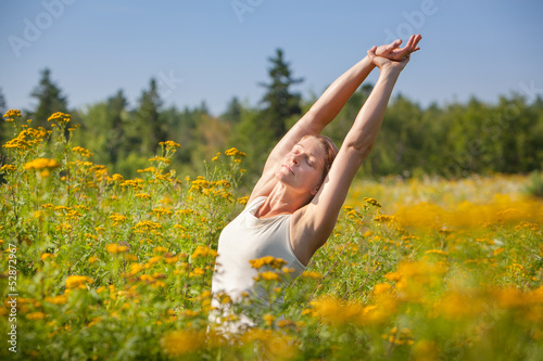 Photo: woman stretching in ragweed flowers woman stretching in ragweed flowers
