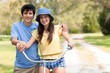 Young man and woman posing on bike
