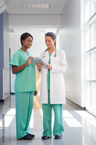 Photo: Female nurse and doctor with tablet computer Female nurse and doctor with tablet computer